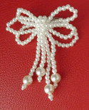 Noeud en perles nacrée blanches - Broche blanche